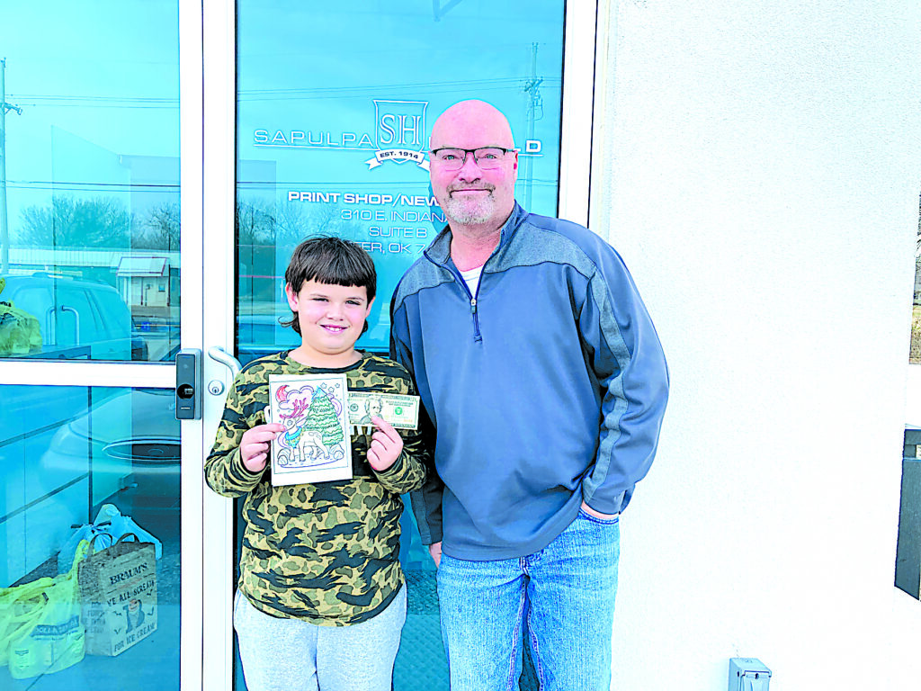 JOHN TRANCHINA PHOTOS Bryce Kirkpatrick, age 9, is a 3rd-grader at Sapulpa’s Freedom Elementary in Ms. Sobawale’s class, standing with Herald Publisher Darren Sumner.