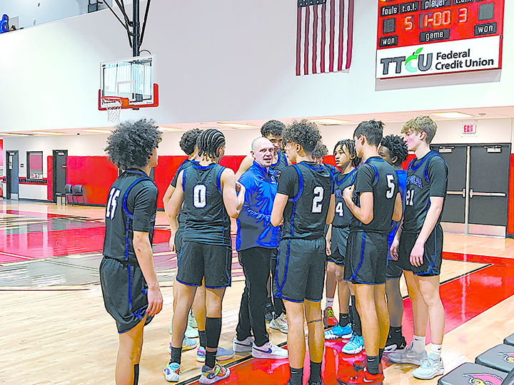 JOHN TRANCHINA PHOTOS SAPULPA CHIEFTAINS COACH JORDAN NAGEL (center) talks things over with his team Thursday in the first round of the tournament