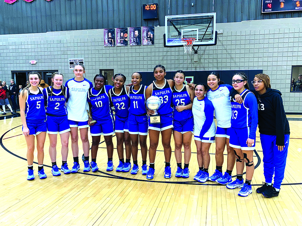 JOHN TRANCHINA PHOTOS SAPULPA LADY CHIEFTAINS DISPLAY THE SILVER BALL TROPHY they won Saturday night for taking second at the Lincoln Christian Winter Classic, following a close 50-44 loss to the host Lady Bulldogs in the final.