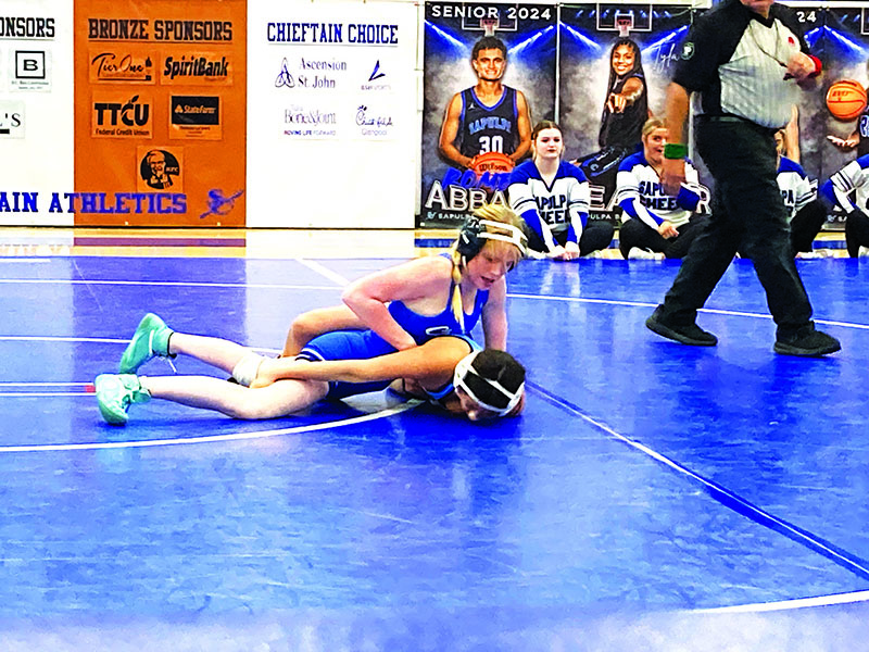 OHN TRANCHINA PHOTO ELISABETH COURVERLER, shown here about to pin her opponent during a dual against Enid on Jan. 4, went 4-2 and placed seventh at 115 pounds in the Sand Springs tournament this past weekend.