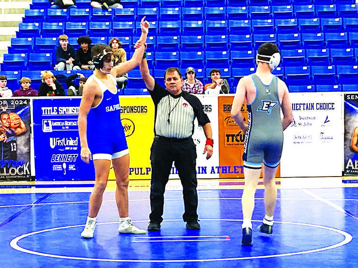JUNIOR BLAKE HURT, shown here getting his arm raised following his victory at last Thursday’s dual against Enid, placed third at 157 pounds at the Larry Wilkey Invitational tournament in Jenks on Saturday