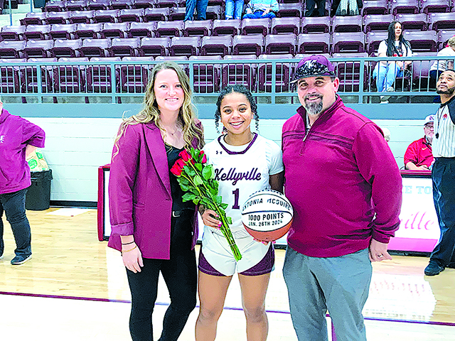 JOHN TRANCHINA PHOTOS SENIOR ANTONIA MCGUIRE was honored by her coach Taylor Todd (left) and Kellyville Athletic Director Kevin Nance, for scoring 1,000 career points. She then scored 12 more Tuesday night.