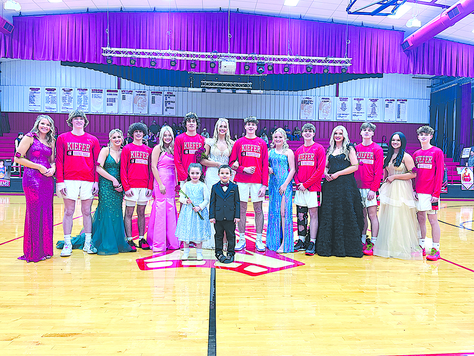 DARREN SUMNER PHOTOS KIEFER 2024 HOMECOMING COURT stands at center court Friday evening prior to tipoff of the basketball game against Cleveland at Caitlyn Mathis Event Center.