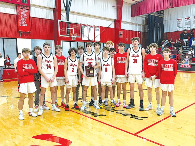 JOHN TRANCHINA PHOTOS
DISTRICT CHAMPIONS The Trojans pose with their plaque after defeating Tahlequah Sequoyah 51-42 on Friday night at the Caitlyn Mathis Event Center. Kiefer next faces Kellyville in the Area III Regionals on Thursday.
