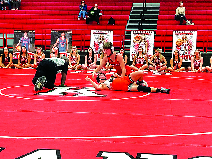 JOHN TRANCHINA PHOTOS FRESHMAN TREY VAN HUIS pinned Grant Clay in 1:42 at 157 pounds, helping the Trojans defeat Morris 36-12 in their dual Thursday night at the Caitlyn Mathis Event Center.