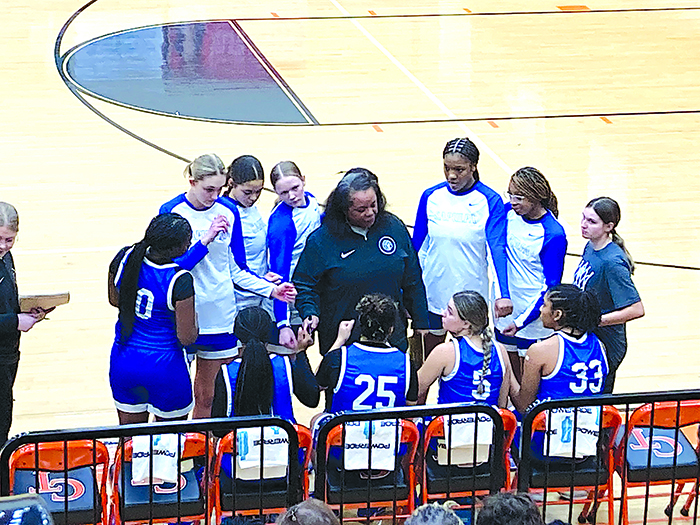 LADY CHIEFTAINS COACH DARLEAN CALIP talks to her team right before tipoff Friday night. Missing one starter, Sapulpa delivered an outstanding performance to defeat Coweta.