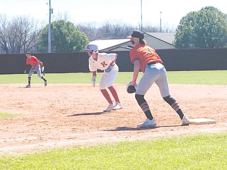FRESHMAN CORD BAHLING takes a lead off of first base Monday. Bahling’s lead-off single in
the bottom of the seventh got the Trojans’ winning rally started.