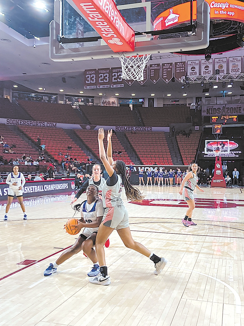 RIKI MCQUARTERS battles underneath the basket, about to put up a layup as part of her nine points. She also pulled down a game-high 13 rebounds Thursday