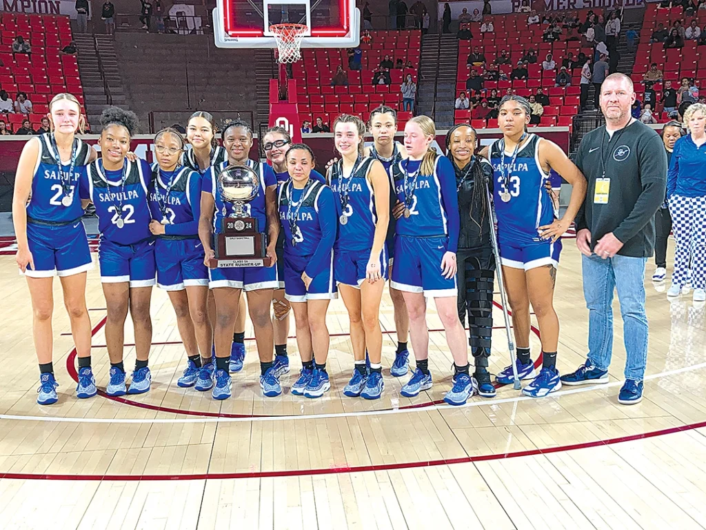 JOHN TRANCHINA PHOTOS SAPULPA STATE RUNNERS-UP With tear-stained eyes, the Lady Chieftains are not very happy while holding the Silver Ball trophy. Athletic Director Michael Rose is far right.