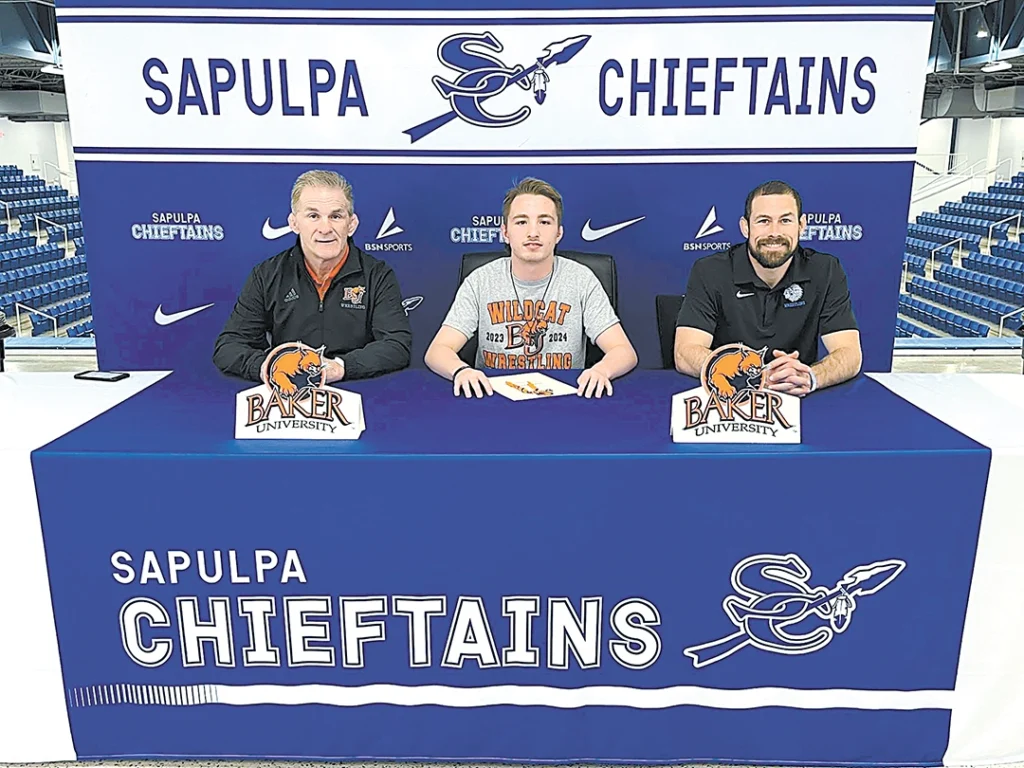 SUBMITTED PHOTO ETHAN PETERSON, Sapulpa Chieftain senior wrestler, at his signing ceremony at the Chieftain Center.