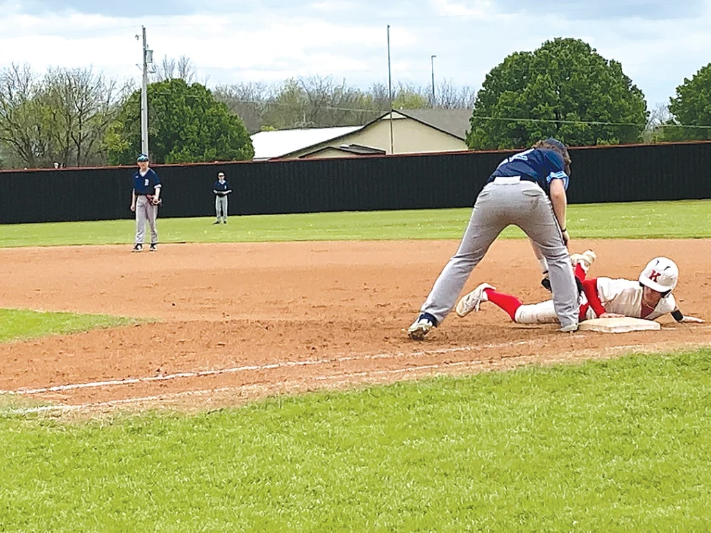 FRESHMAN OUTFIELDER JACKSON WELLS dives back to first base during a second inning pickoff attempt on Saturday. He eventually scored.