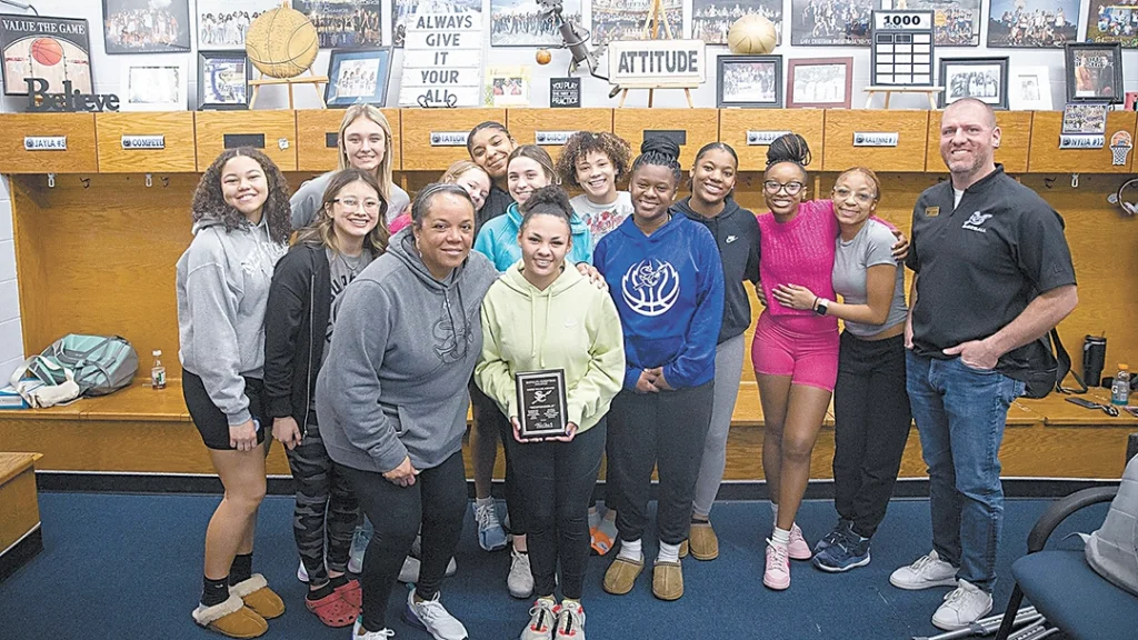 SUBMITTED PHOTOS JAYLA MOTON (center) stands with her Core Value Award plaque, surrounded by her Lady Chieftain teammates and coach Darlean Calip, as well as Athletic Director Michael Rose (far right).