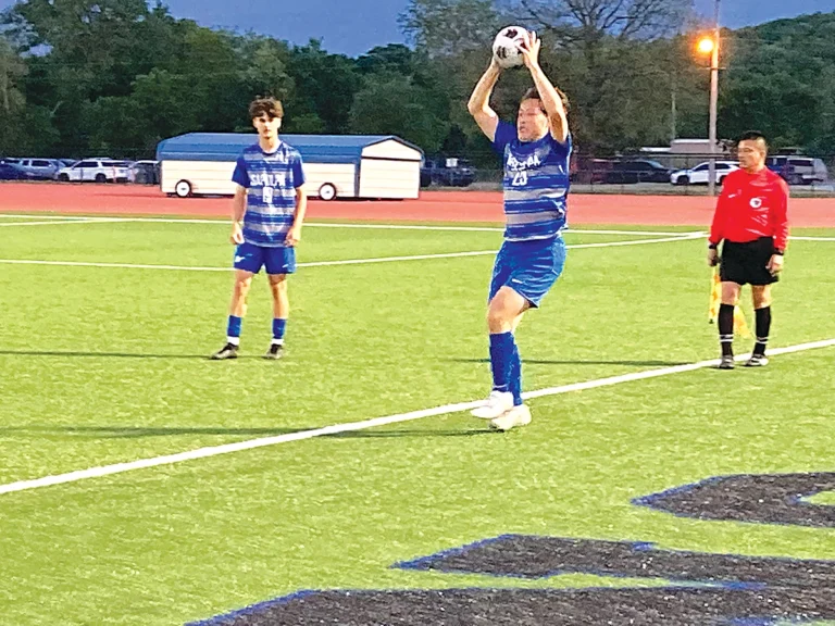 JUNIOR KYLE HILLSBERRY in the process of a throw-in, while Deacon Hillsberry looks on,
during Tuesday’s season finale.