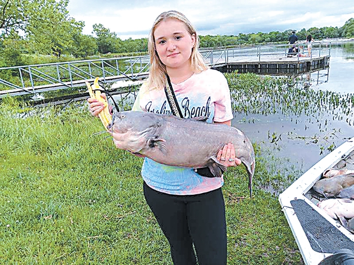 CHARLES BETZLER PHOTOS
A LOCAL ANGLER shows off a giant catfish she caught recently.