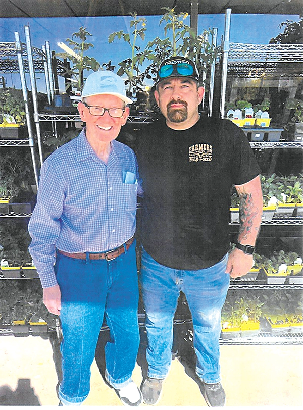 DON DIEHL PHOTO At the Farmers Feed Store entranceway this past week are Gene Lamb (left) and Bobby Parrick (right), who has been an employee for several years.