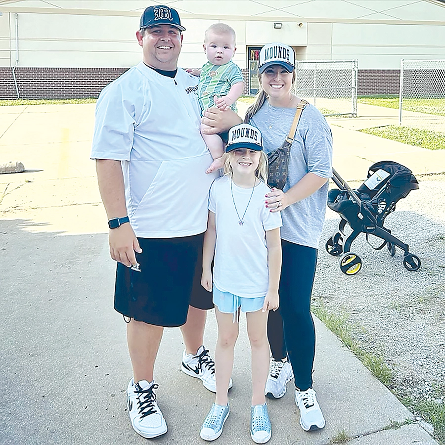 SUBMITTED PHOTO NEW MOUNDS HEAD FOOTBALL COACH JONATHAN STOWE (left), shown here with his family, takes over the Golden Eagles after six years as defensive coordinator at Hominy, where he helped the Pirates reach the state semifinals.
