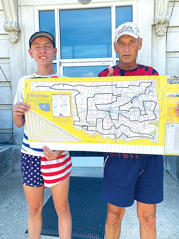 SUBMITTED PHOTOS
TITUS ELLIS (Left) AND RANDY ELLIS hold up the map detailing their path across Oklahoma
after finishing their final leg at the Creek County Courthouse in Sapulpa on June 15.