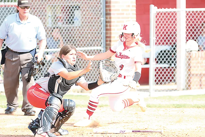 DARREN SUMNER PHOTOS KAMMIE SMITH, a Kiefer senior who has committed to Wichita State, slides safely into home plate Tuesday afternoon at home against the Keys Cougars. The Lady Trojans started the new season 1-1.