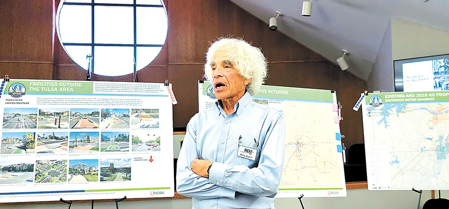 CHARLES BETZLER PHOTOS MARTY SHUKER of RDG Planning and Design, standing in front of one of the poster boards, addressed the INCOG GO Plan during Tuesday’s meeting.