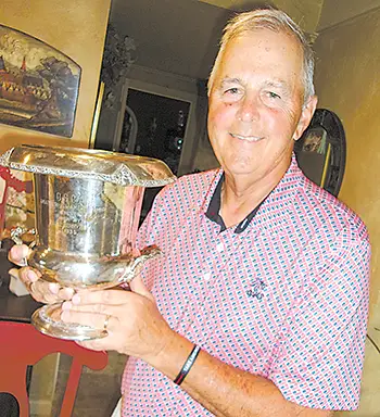 Brian Bingman of Sapulpa is shown here with his grandfather’s “cup” presented him in 1935 after winning the National Amateur Golfer title.