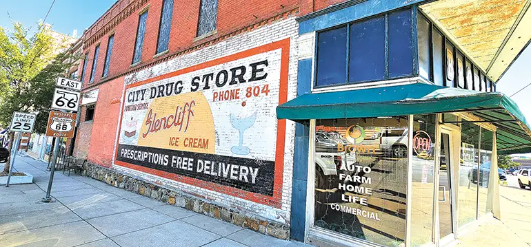 CHARLES BETZLER PHOTO Restored advertising on the side of what once was City Drug, and is now Brown Insurance agency, highlights the fact that City Drug featured a soda fountain. Note the old three-digit phone number.