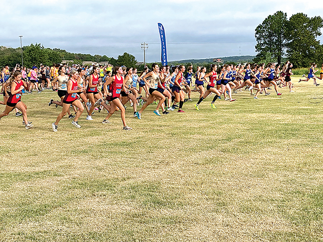 STARTING LINE The mad dash in the girls’ two-mile race at the starting line, just after the siren went off. Sapulpa girls are on the right.