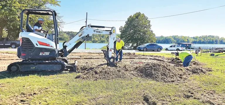 CONSTRUCTION FINALLY UNDERWAY David Garcia, Jesus Palacias and Rogela Luerens,
employees of Rojo Red Concrete, begin excavation for the concrete slab of the new bathroom
and showers at Lake Sahoma.