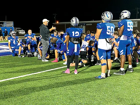 DISAPPOINTED CHIEFTAINS gather after the game, as Coach Tim Holt talks things over
following the heart-breaking 7-3 loss to Putnam City North Friday night.