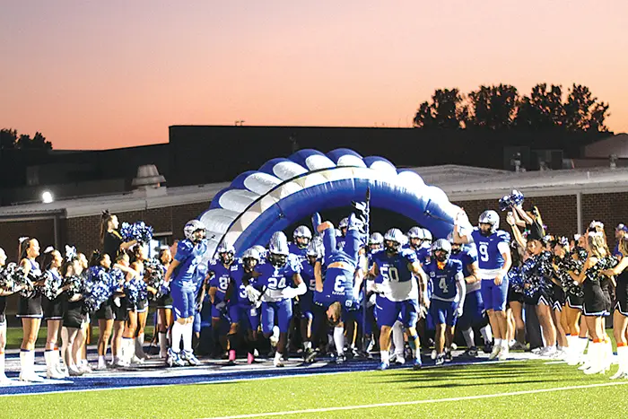 JOHN TRANCHINA PHOTO
CHIEFTAINS HYPED UP Senior LOGAN HICKS (3, center) does a backflip as the Chieftains
charge out of the tunnel last week before their game against PC North