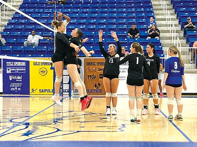 JOHN TRANCHINA PHOTO
ABBY ADMIRE (left) and Audrey Forth celebrate a recent point with a leaping chest bump, while
Mady Greenfeather (right) cheers.