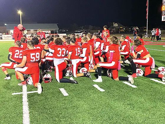 KIEFER COACH TRENT WORLEY (left) speaks to his team after their clutch 30-28 comeback
victory over Hugo last Thursday night at home. The Trojans are on the road at Bethel Friday
night.