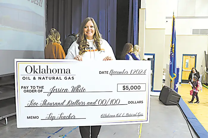 JESSICA WHITE holds her oversized novelty check after being named one of the OERB’s top
20 Teachers of 2024-25.