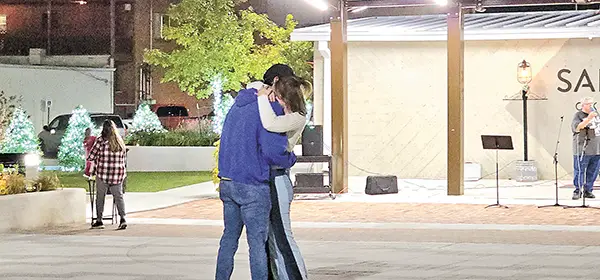 A young man and woman slow dancing at the Steve Ethridge concert at Herald Square.
Spencer Trammel and his fiancee Kristyn Trammel, who are to be wed soon, were dancing to
Elton John’s "A Little Bit Funny" which is "their song