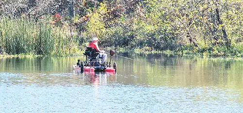 A LONE ANGLER fishing on Pretty Water in his rather unique one-man fishing boat.