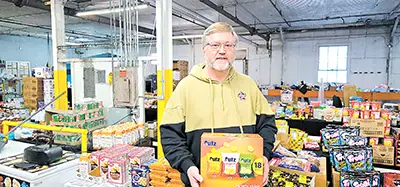 CHARLES BETZLER PHOTO
JEFF SCHWICKERWRATH holds box of chips at his store, Swick’s Liquidation.