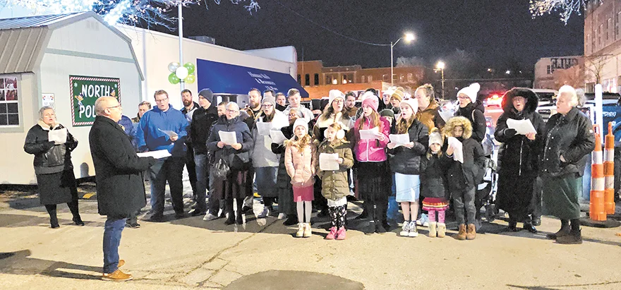 CHARLES BETZLER PHOTO The Church of God on Frankoma Road Choir sings Christmas carols and hymns for Christmas Chute goers.