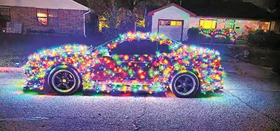 CHARLES BETZLER PHOTO
ERIC LUNA’s dazzling display of Christmas lights on his Ford Mustang definitely stands out in
traffic.