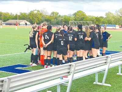 JOHN TRANCHINA PHOTOS COACH LORI ARUNDELL (center) talks things over with the Lady Chieftains after their 2-0 victory over Edison in the regular season finale on Tuesday night. Sapulpa travels to Claremore for their first-round playoff game Monday night.