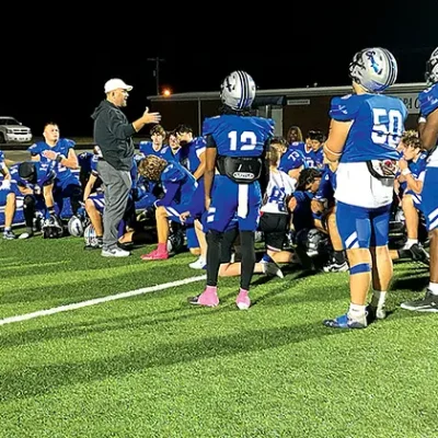 DISAPPOINTED CHIEFTAINS gather after the game, as Coach Tim Holt talks things over following the heart-breaking 7-3 loss to Putnam City North Friday night.