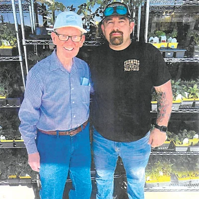 DON DIEHL PHOTO At the Farmers Feed Store entranceway this past week are Gene Lamb (left) and Bobby Parrick (right), who has been an employee for several years.